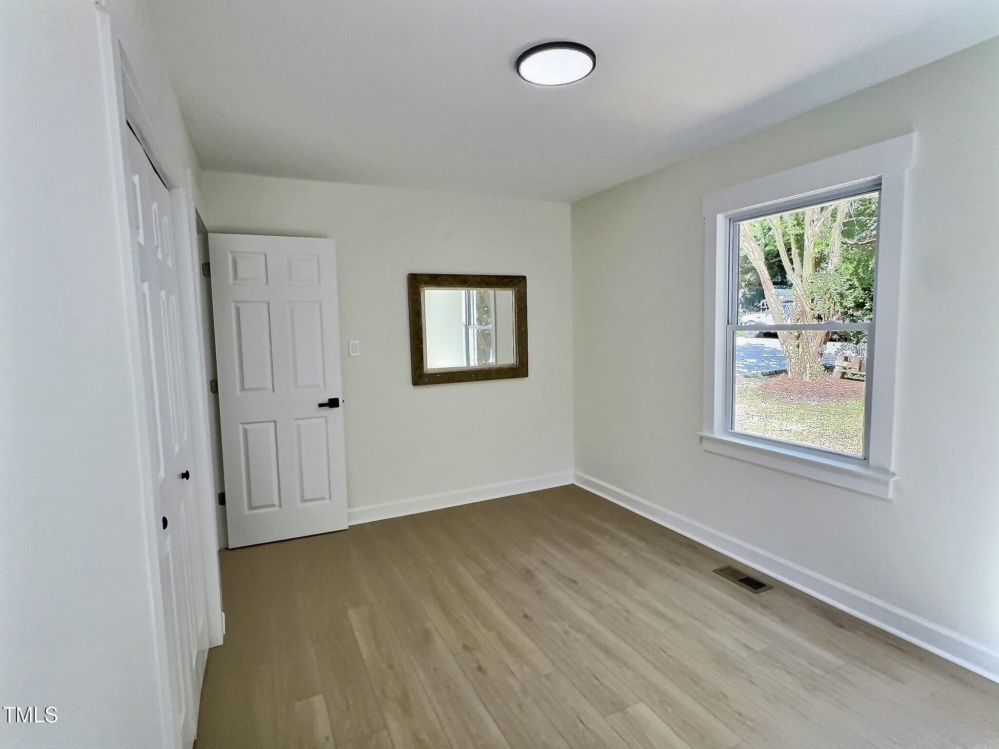 116 Lumpkin Street Raleigh, NC 27610 - Photo 15 of 20 wooden floor in an empty room with a window