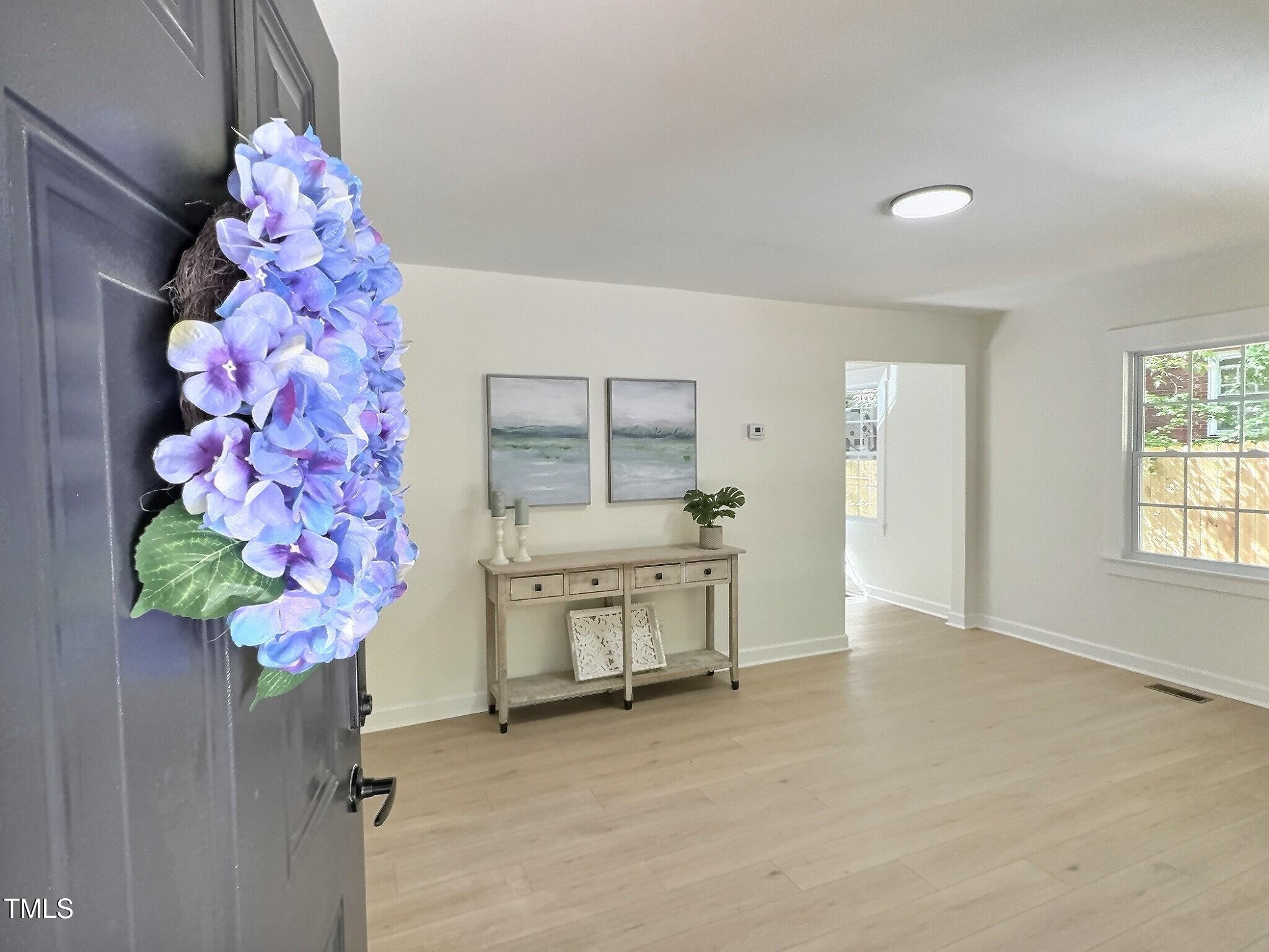 116 Lumpkin Street Raleigh, NC 27610 - Photo 4 of 20 wooden floor in an empty room with a window