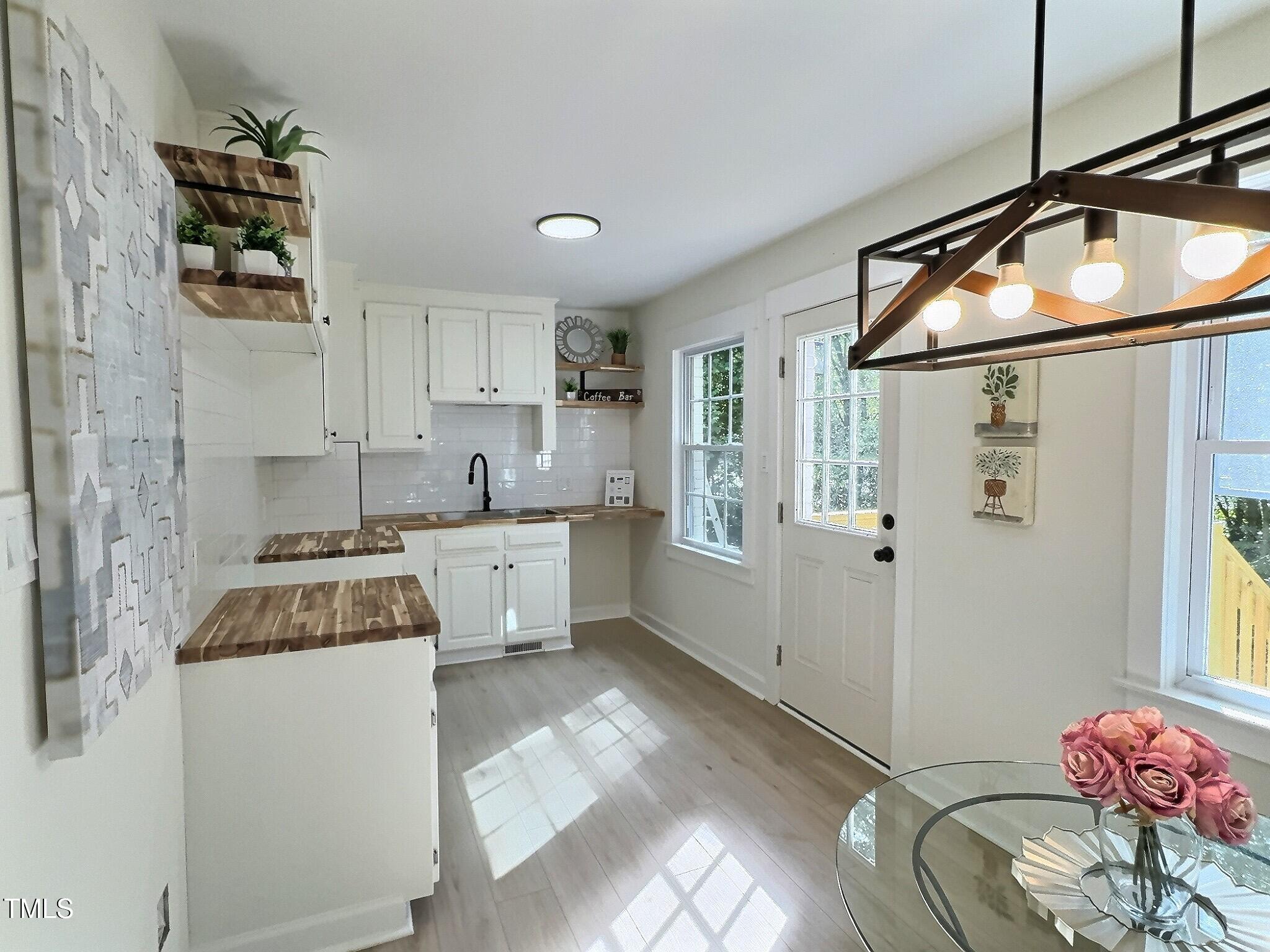 116 Lumpkin Street Raleigh, NC 27610 - Photo 9 of 20 a kitchen with a sink a stove and cabinets