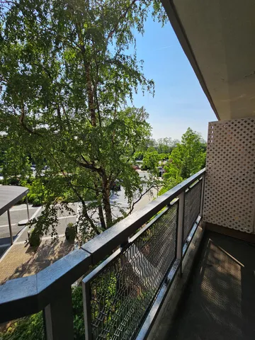 a balcony with wooden floor and fence