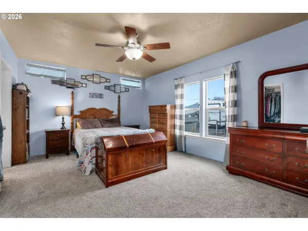 a living room with furniture a ceiling fan and a window