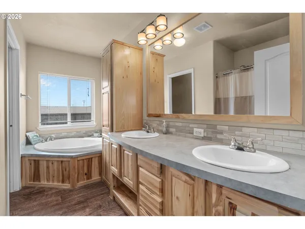 a bathroom with a sink double vanity and a bathtub
