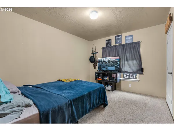 a bed room with a bed and a lamp