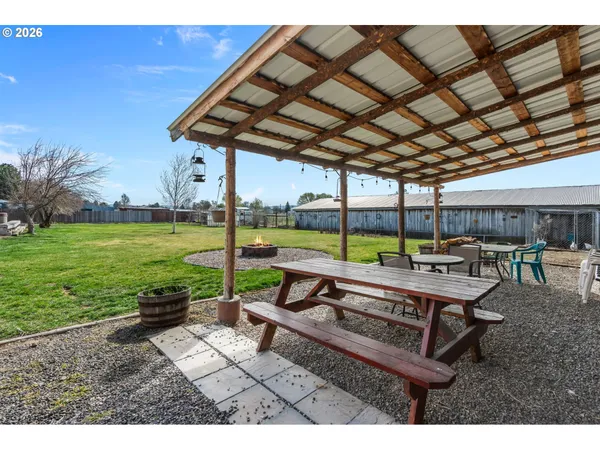a view of a patio with a table chairs and a backyard