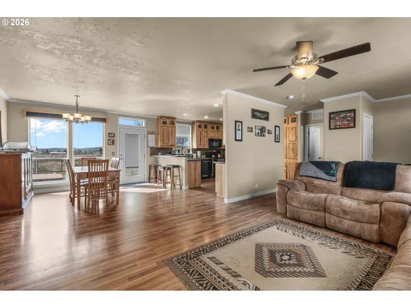 a living room with furniture and kitchen view