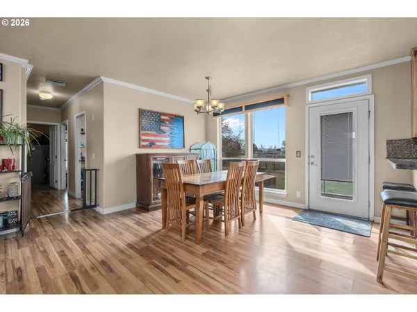 a dining room with furniture window and wooden floor
