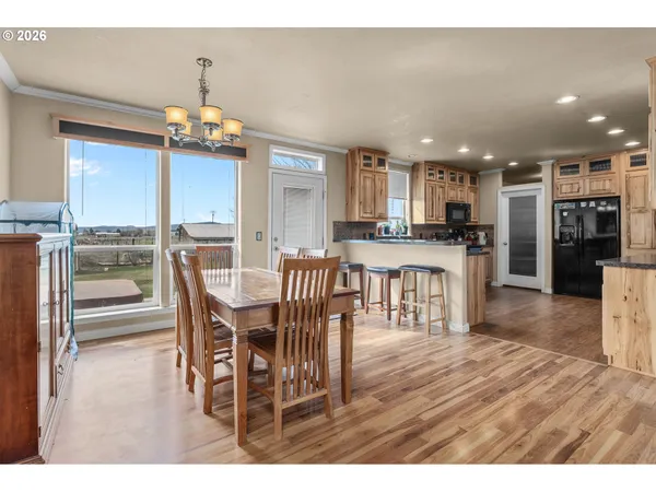 a dining room with furniture a chandelier and wooden floor