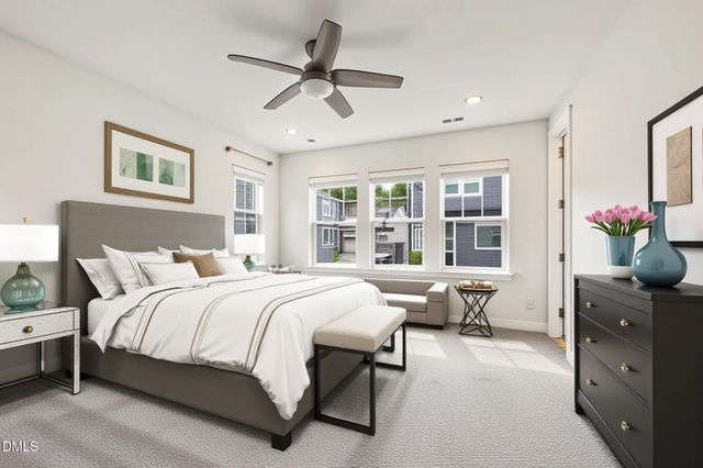 a bedroom with a large bed and a window