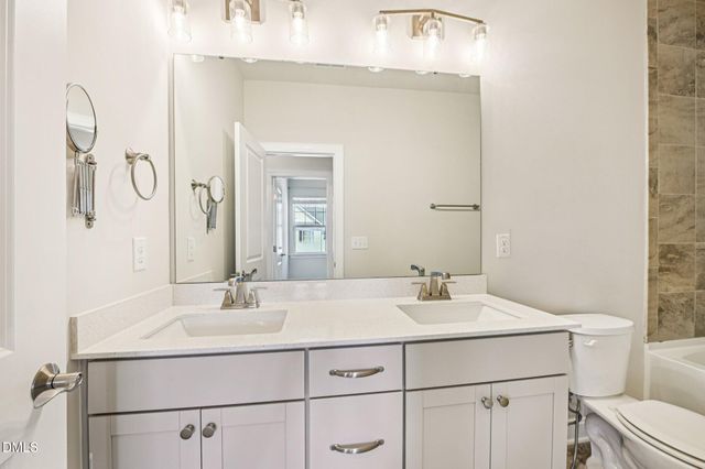 a bathroom with a sink vanity and a mirror