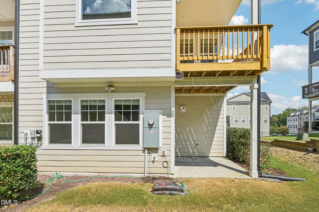 a view of a brick house with many windows