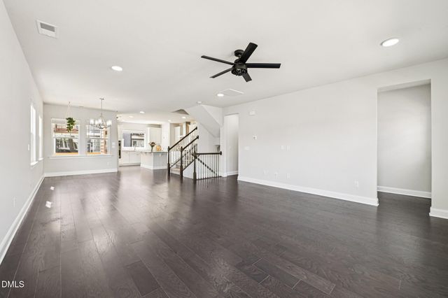 a view of a livingroom with a hardwood floor and a ceiling fan