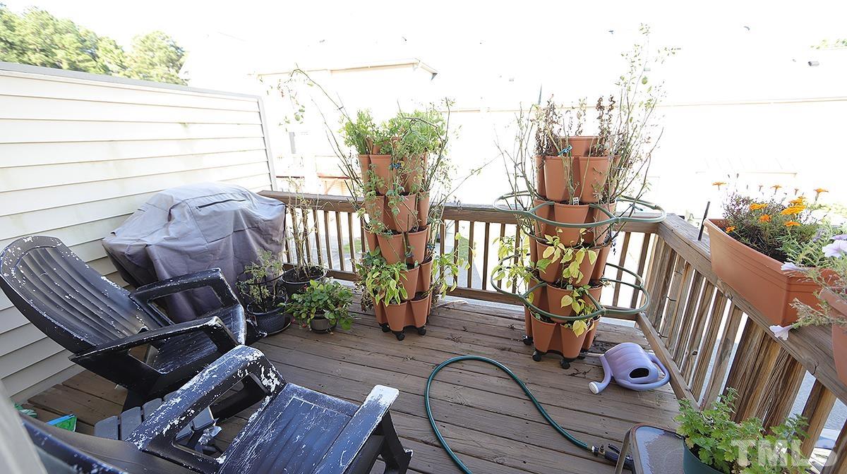 9818 Grettle Court Raleigh, NC 27617 - Photo 11 of 14 a view of balcony with chairs and wooden fence