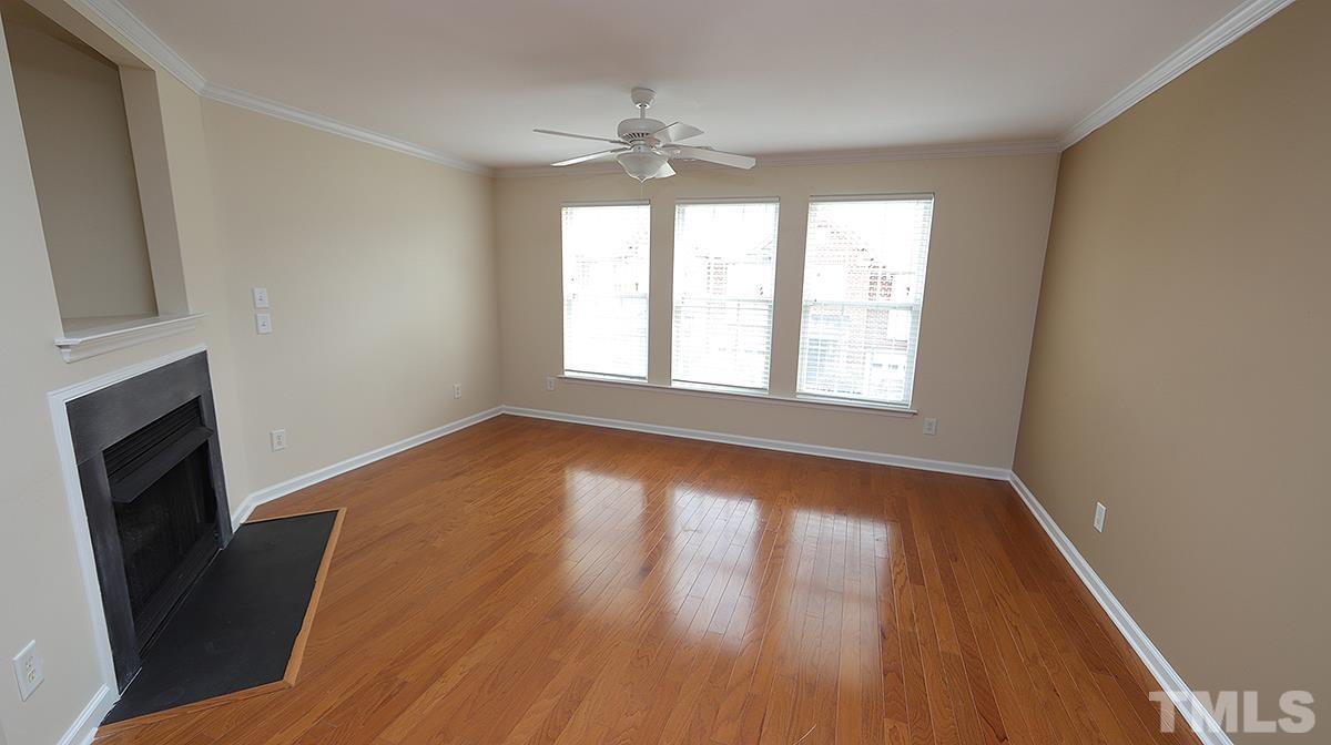 9818 Grettle Court Raleigh, NC 27617 - Photo 14 of 14 a view of an empty room with wooden floor and a window
