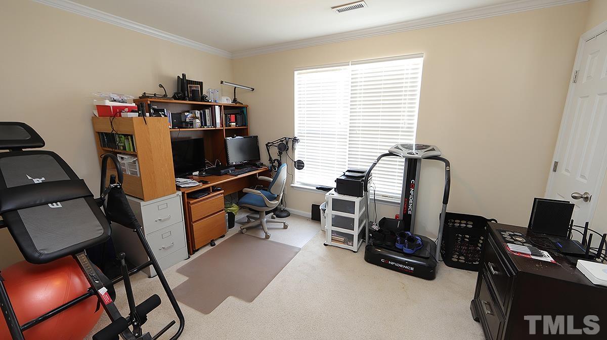 9818 Grettle Court Raleigh, NC 27617 - Photo 7 of 14 a view of a workspace with furniture and a window