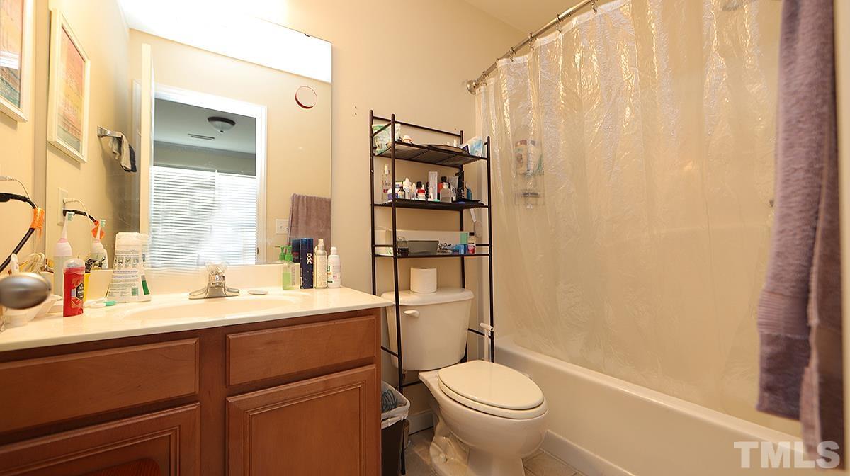 9818 Grettle Court Raleigh, NC 27617 - Photo 8 of 14 a bathroom with a sink a toilet and shower