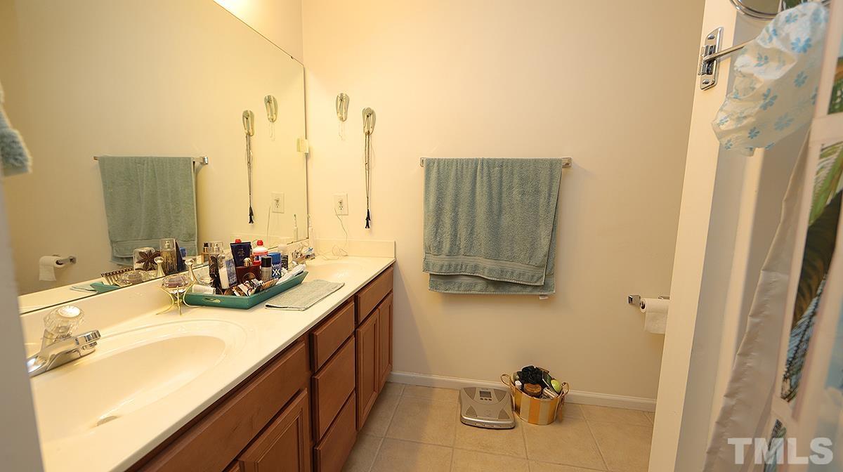 9818 Grettle Court Raleigh, NC 27617 - Photo 10 of 14 a bathroom with a sink and a mirror