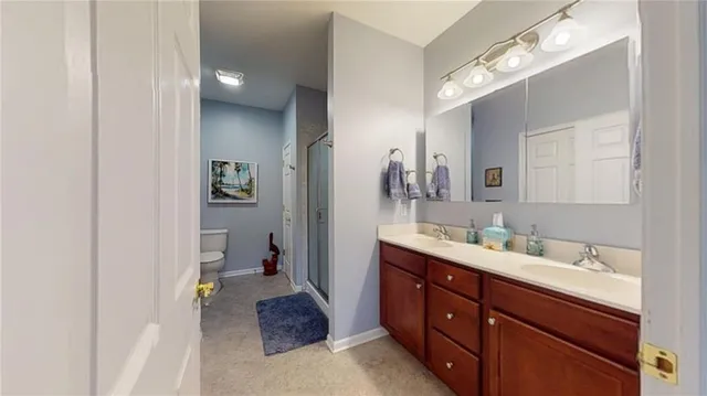 a en suite bathroom with a double vanity sink and a mirror
