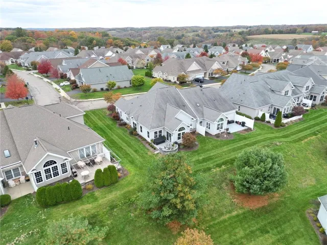 an aerial view of residential houses with outdoor space