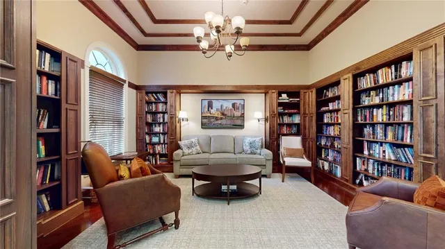 a living room with fireplace furniture and a book shelf