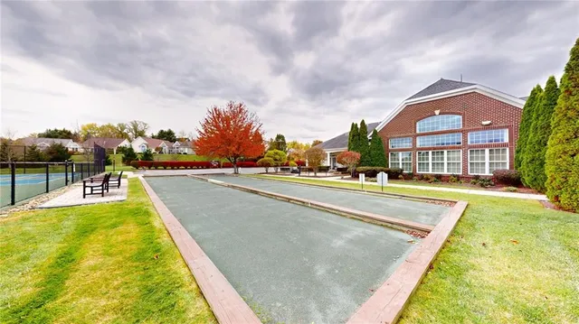 a swimming pool with outdoor seating and yard