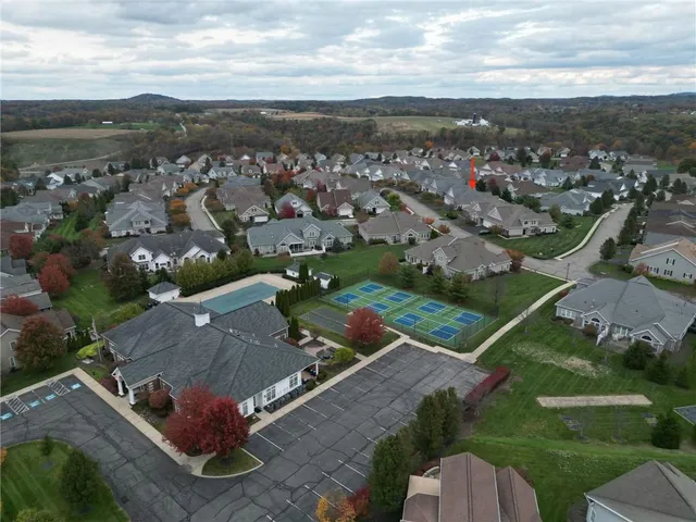 an aerial view of residential houses with outdoor space and river