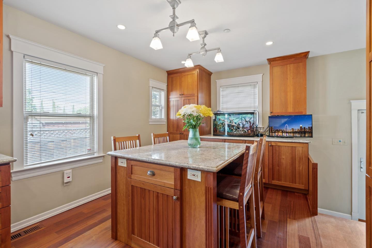 142 16th Avenue San Mateo, CA 94402 - Photo 12 of 25 a kitchen with kitchen island granite countertop a stove a sink and a refrigerator