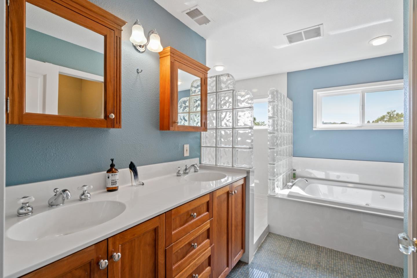 142 16th Avenue San Mateo, CA 94402 - Photo 20 of 25 a bathroom with a sink double vanity and a mirror