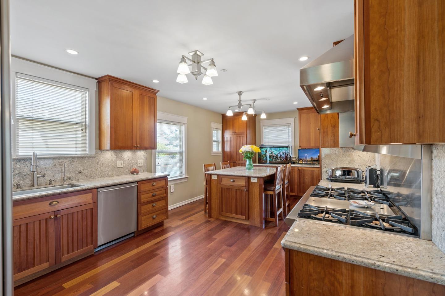 142 16th Avenue San Mateo, CA 94402 - Photo 8 of 25 a large kitchen with stainless steel appliances granite countertop a stove and a wooden floors