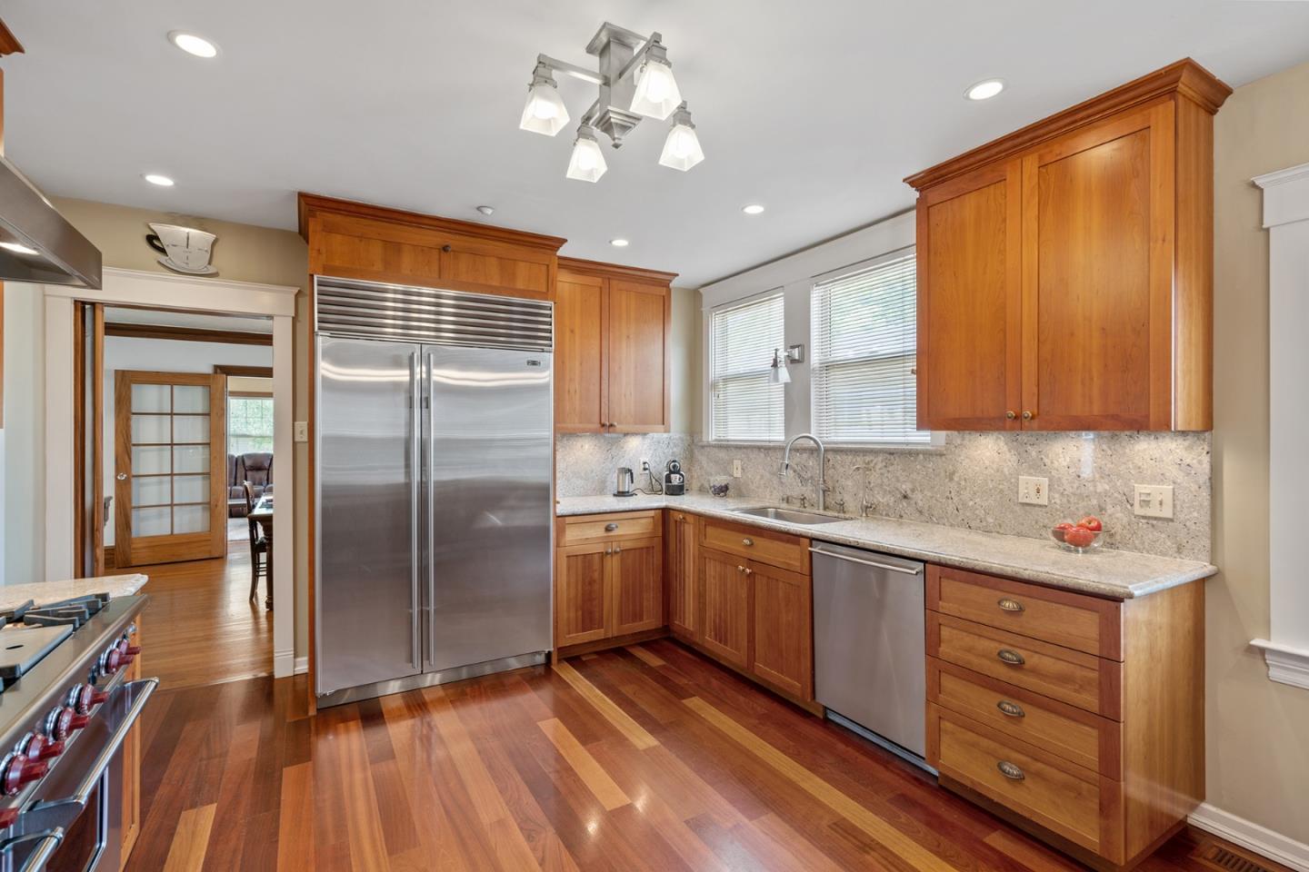 142 16th Avenue San Mateo, CA 94402 - Photo 9 of 25 a kitchen with stainless steel appliances granite countertop a refrigerator a sink dishwasher a stove and white countertops with wooden floor