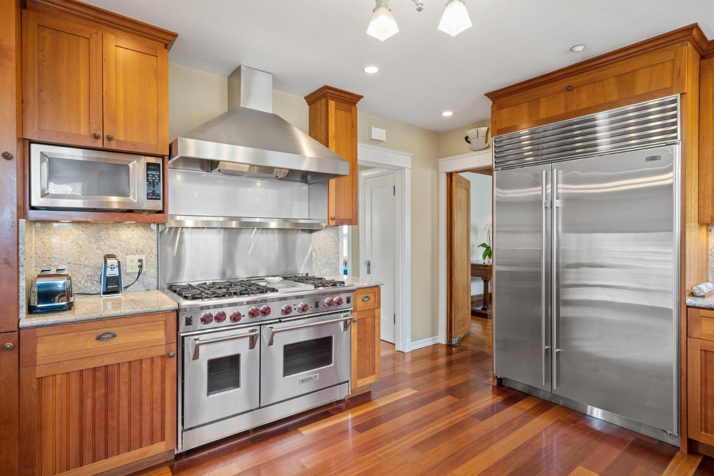 142 16th Avenue San Mateo, CA 94402 - Photo 10 of 25 a kitchen with stainless steel appliances a stove and a refrigerator