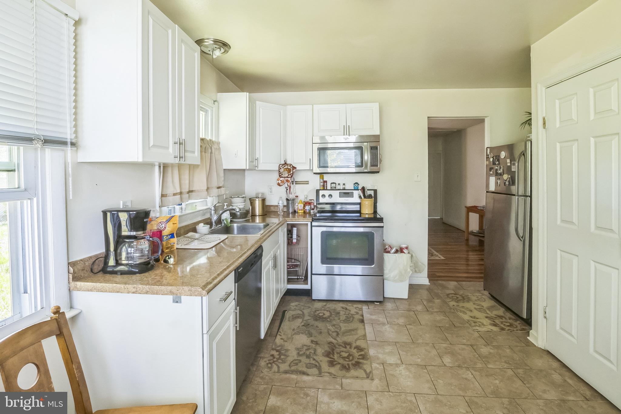 9 Queens Way Newark, DE 19713 - Photo 13 of 28 a kitchen with refrigerator and cabinets