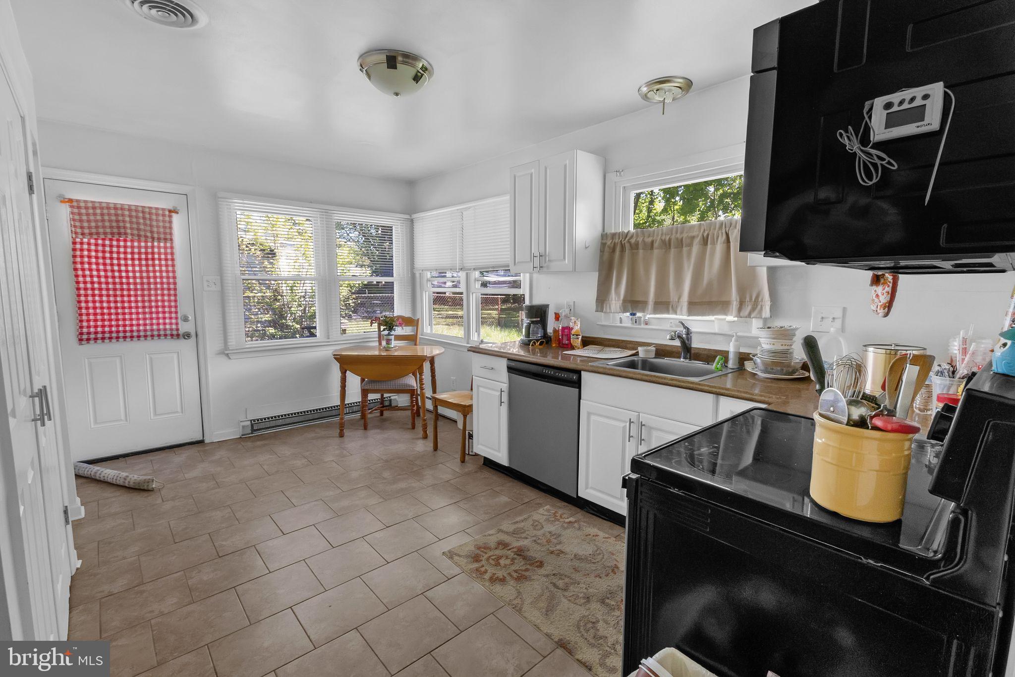 9 Queens Way Newark, DE 19713 - Photo 14 of 28 a kitchen with a sink cabinets and window
