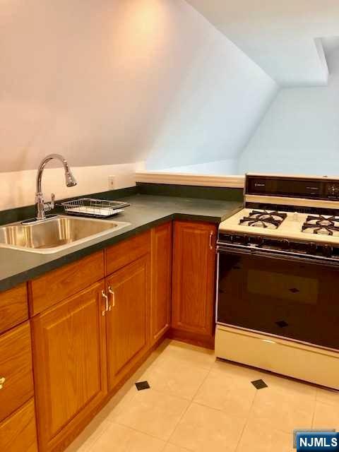 21 Columbus Street Bloomfield, NJ 07003 - Photo 15 of 20 a kitchen with granite countertop a stove and a sink