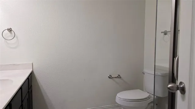 a bathroom with a glass shower door