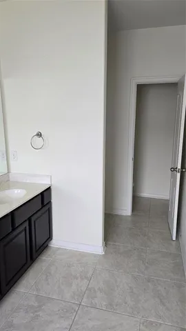 a bathroom with a bathtub next to a window
