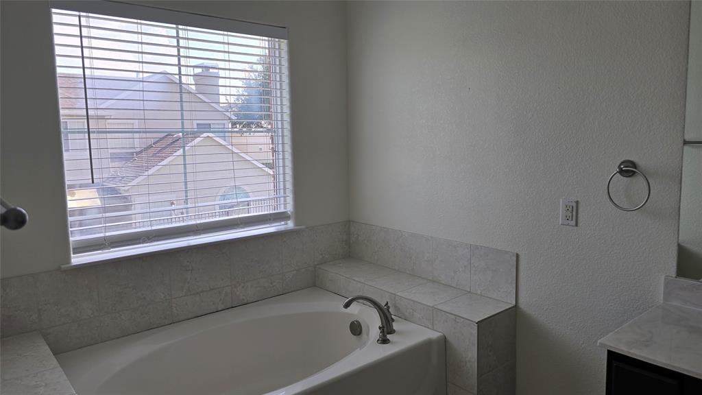 706 South Jupiter Road, Unit 1507 Allen, TX 75002 - Photo 28 of 31 a bathroom with a bathtub next to a window