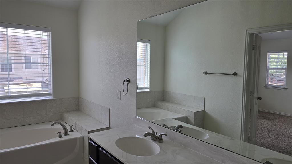 706 South Jupiter Road, Unit 1507 Allen, TX 75002 - Photo 29 of 31 a bathroom with a tub sink and mirror