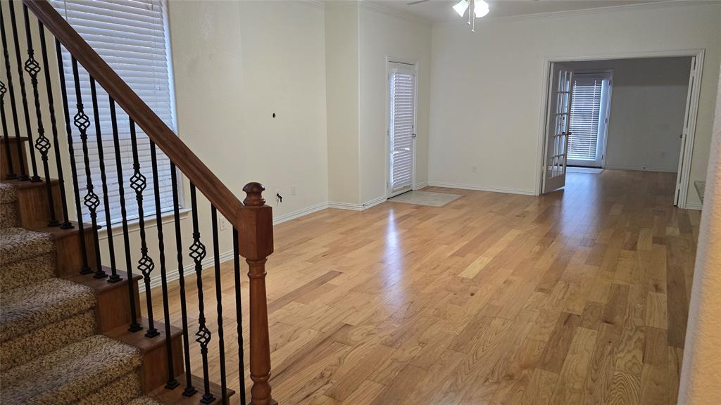 706 South Jupiter Road, Unit 1507 Allen, TX 75002 - Photo 6 of 31 a view of a hallway with wooden floor and staircase