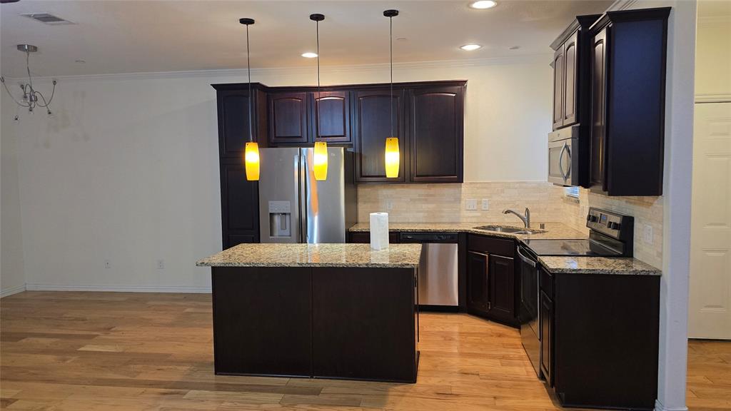 706 South Jupiter Road, Unit 1507 Allen, TX 75002 - Photo 8 of 31 a kitchen with stainless steel appliances granite countertop a stove a sink and a refrigerator