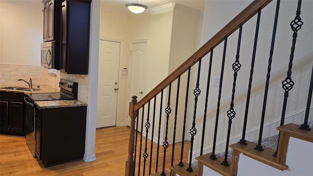 706 South Jupiter Road, Unit 1507 Allen, TX 75002 - Photo 9 of 31 a view of a hallway with wooden floor and staircase