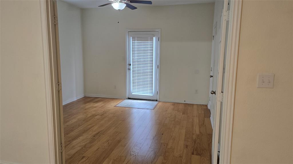 706 South Jupiter Road, Unit 1507 Allen, TX 75002 - Photo 10 of 31 an empty room with wooden floor and windows