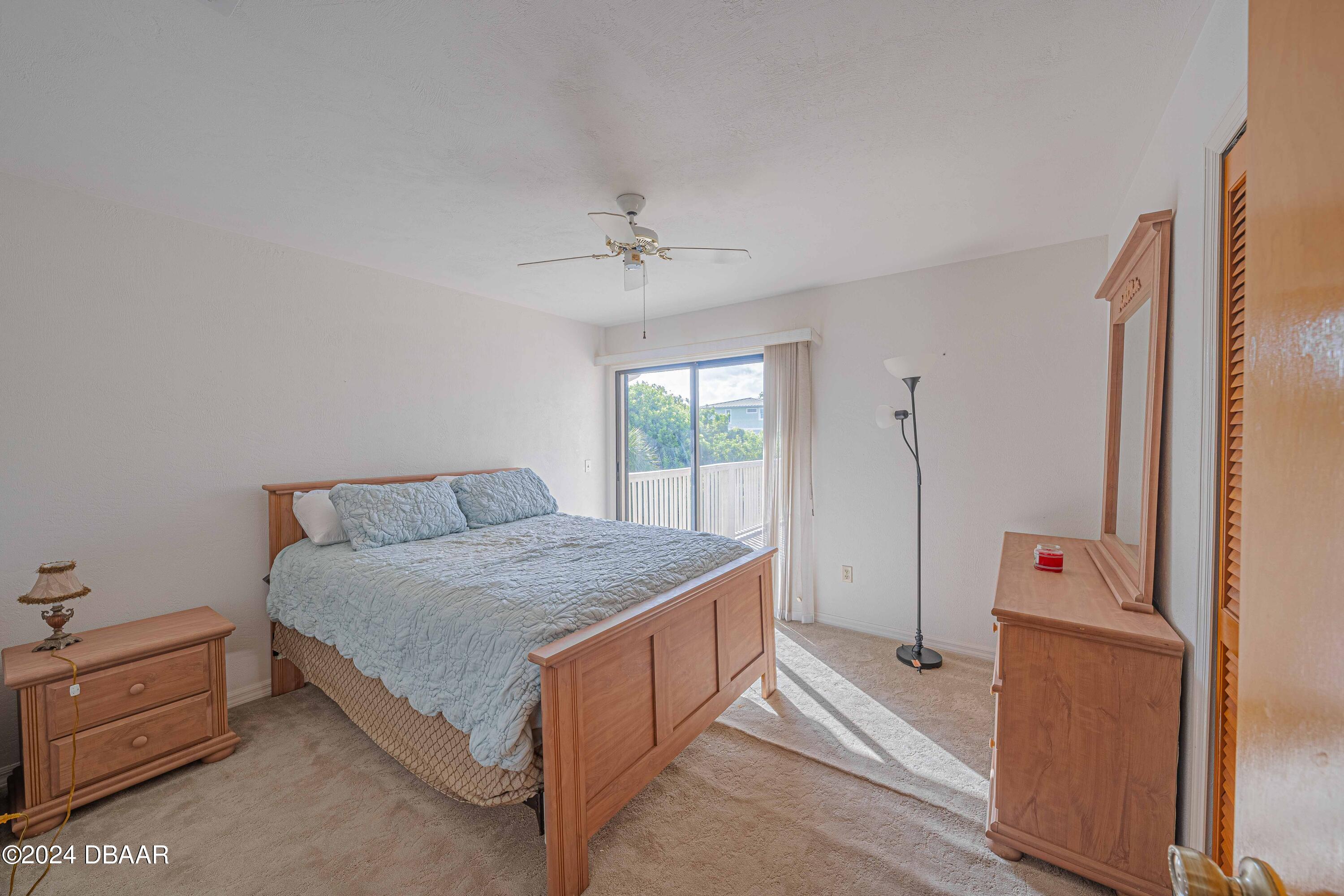 42 Jana Drive Ponce Inlet, FL 32127 - Photo 8 of 34 a spacious bedroom with a bed and a window