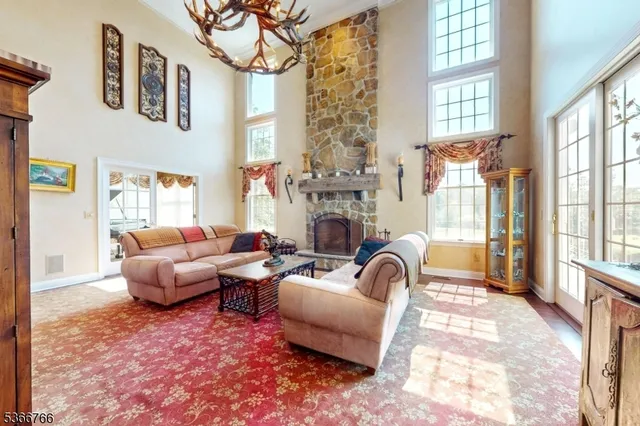a living room with furniture a fireplace and a large window