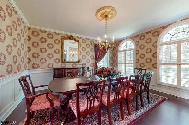 a view of a dining room with furniture wooden floor and chandelier