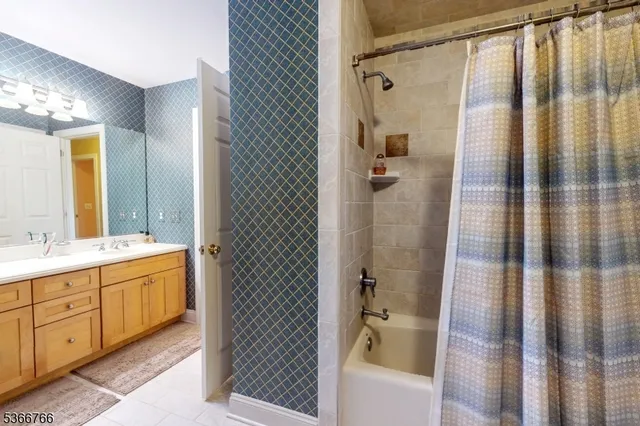 a bathroom with a double vanity sink a toilet and shower