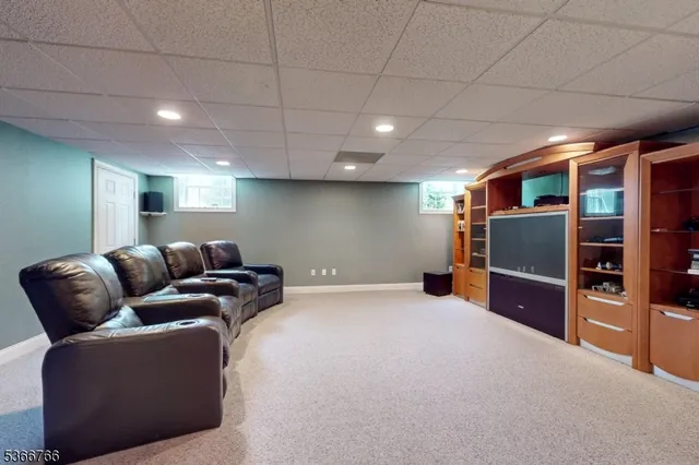 a living room with furniture and a ceiling fan