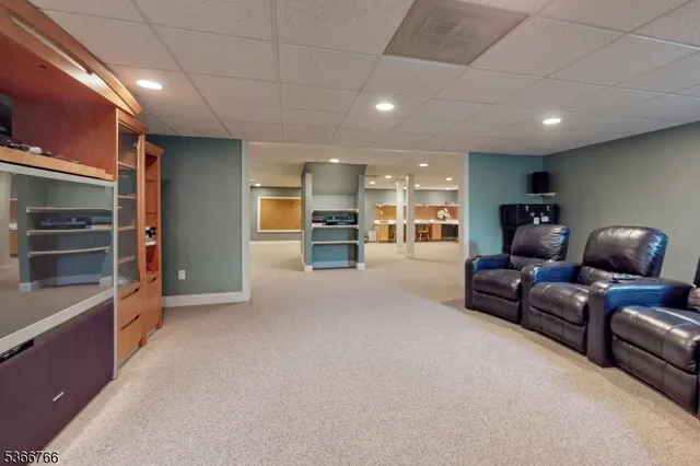 a living room with furniture and a kitchen