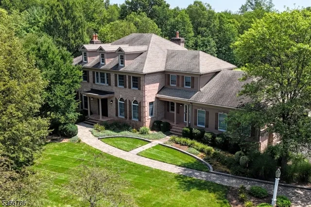 a aerial view of a house with swimming pool and garden