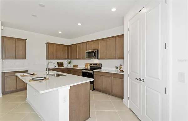 a kitchen that has a sink and a stove in it