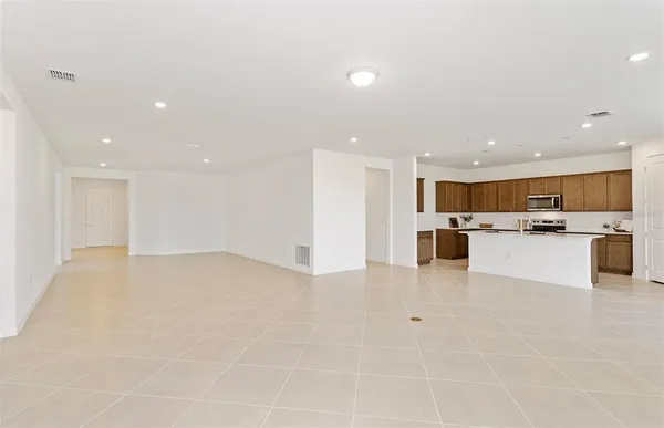 a view of kitchen with kitchen island white cabinets and stainless steel appliances
